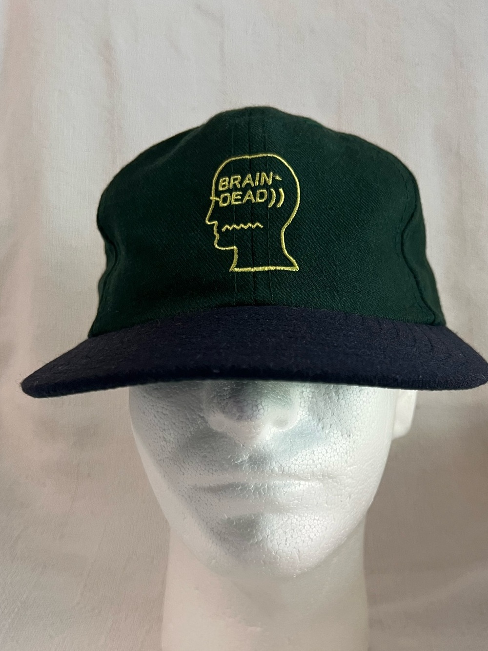 Brain Dead Green Crown Navy Brim Cap with Yellow Head Logo and Black leather